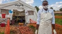 A medical officer in front of a Malawi Cholera Treatment Centre