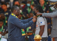 President Macky Sall decorates coach Cisse with his national award