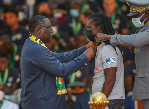 President Macky Sall decorates coach Cisse with his national award