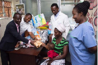 Representative of Bishop Adonteng Boateng donating the money to the mother