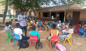 Children learning under a tree