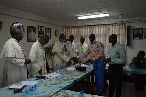 Sarfo Kantanka presenting the Cheque to Archbishop Palmer-Buckle while the other Bishops look on.