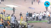 Black Stars players escaping chaotic scene at the Abuja stadium