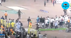 Black Stars players escaping chaotic scene at the Abuja stadium