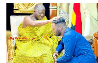 Asantehene, Otumfuo Osei Tutu II laying his hand on the doctor