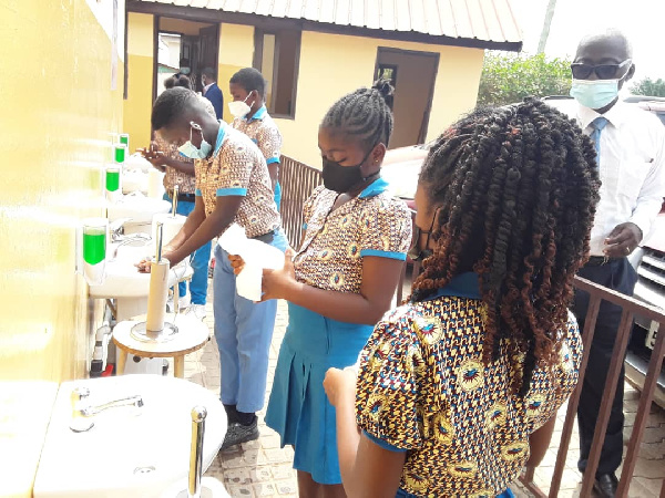 Some students of the school adhering to the protocols