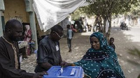 A woman casts her ballot at a roadside polling station in N'djamena