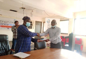 Mr.Boateng, Head of Finance at WRC, presenting the documents to Mr. Jacob