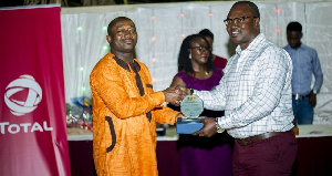 A dealers receiving his reward from Total Petroleum Ghana Limited