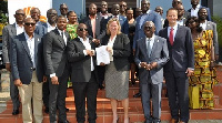 Patrick Akorli, Randi Cruz (with the document) while Kwamena Bartels and other members look on