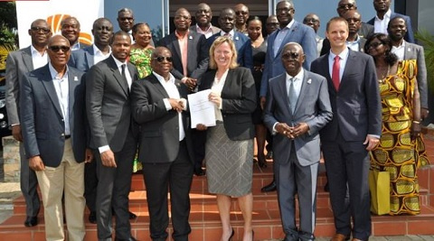 Patrick Akorli, Randi Cruz (with the document) while Kwamena Bartels and other members look on