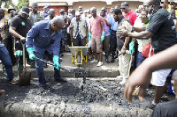 Former President John Dramani Mahama desilting gutters in Accra