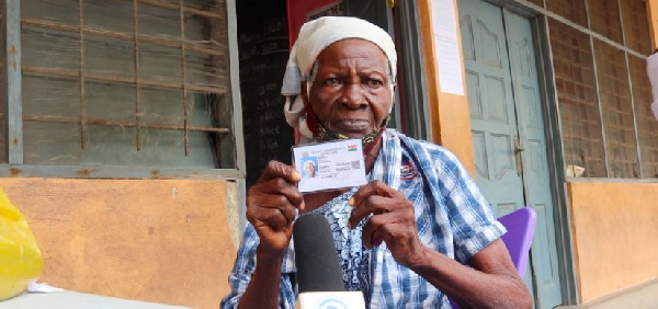 Madam Victoria Akutey with her new voters ID card