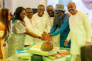 Kwesi Pratt Jnr (fourth left) cuts his 70th birthday cake with wellwishers