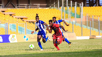 Accra Great Olympics and Asante Kotoko in a hard tackle for the ball