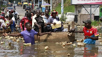 Residents in Kinshasa have been using canoes on the city's flooded roads