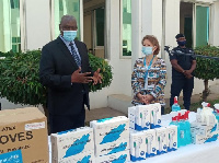 Madam Anne-Claire Dufay (right) presenting the PPEs to Mr Frank Raji (left) and Rev Kingsley Asare A