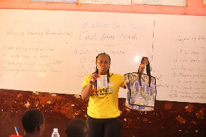 The school children being educated on how to recycle sachet water rubbbers into shopping bags