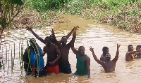 Some of the residents of Kibi, swimming in the water