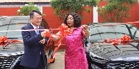 Jung-Taek Lim (left)  presents the vehicles to Shirley Ayorkor Botchwey (right)