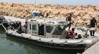 Tunisian coastguards with rescued migrants | File photo