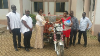 Barbara Oteng-Gyasi presenting the tricycle to the wife of John Enimil