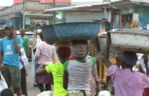 File Photo: Some head porters engaged in their trade