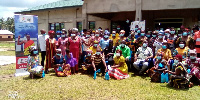 Kenneth Kponor, Volta Regional Director of NCCE with residents in a group picture