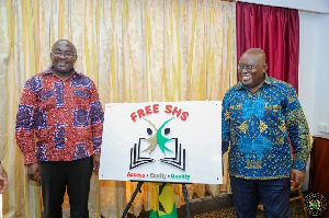 President Akufo-Addo and Dr Bawumia stand side by side a Free SHS signboard