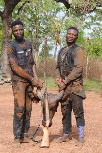 The 2 notorious poachers holding the head of the Buffalo