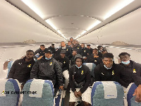 Black Stars in a group photo aboard their plan upon arrival