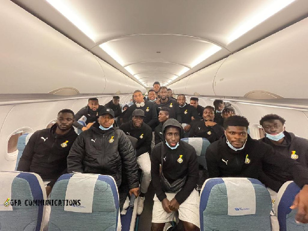 Black Stars in a group photo aboard their plan upon arrival