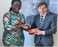 Mrs. Ursula Owusu-Ekuful, Minister for Communications presenting a gift  to Mr Jean-Marc Sere-Chalet