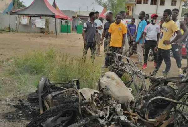 Three motorbikes were burnt on Monday in a chaos that erupted at a registration center in Kasoa