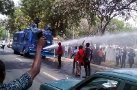 Water cannons containing hot chemical solution being used on protestors