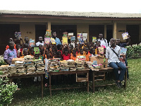 Students in a group photograph with items donated