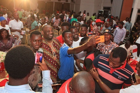 Publisher of Ovation Magazine, Chief Dele Momodu surrounded by youth taking turn for selfie