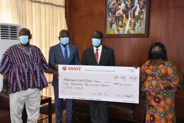 Officials of SSNIT handing over the cheque to the Chief of Staff