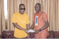 Musician BB (left) shakes hands with Sidi Adams (right)