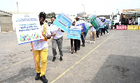 Staff of GPHA holding placards with messages on occupational health, safety and environment