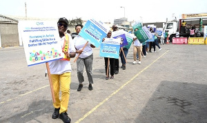 Staff of GPHA holding placards with messages on occupational health, safety and environment