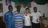 Coach Yatsuhashi, second from right, in the cloth presented by Hearts fans