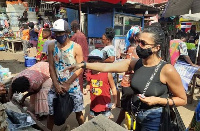 Gama is pictured with his family buying local foodstuffs in Kumasi Central market