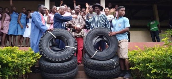 MP Kpodo (second left) presenting the tyres to the headmaster