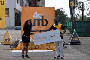 Mr John Awuah (R) presenting the check to Ms Yvonne Botchey