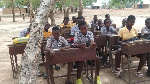The 55 pupils and their tutors take their lessons under trees despite the heat produced