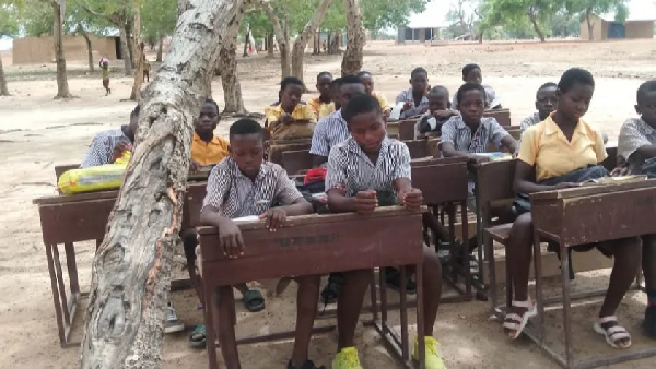 The 55 pupils and their tutors take their lessons under trees despite the heat produced