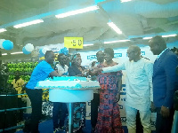 The dignitaries cutting the cake for the opening of the shop