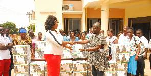 Mrs. Okity-Duah (left) presenting the books to Mr. Fosu-Danquah