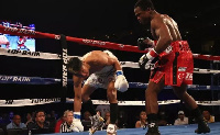 Hidenori Otake (L) of Japan stumbles in his fight with Isaac Dogboe of Ghana